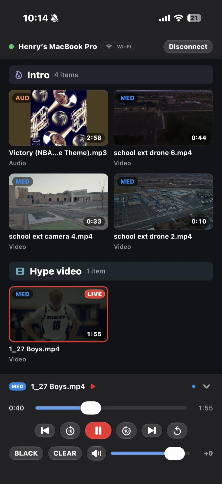 The iPhone remote app connected over Wi-Fi: clip grid with one live, transport controls and fader at the bottom.